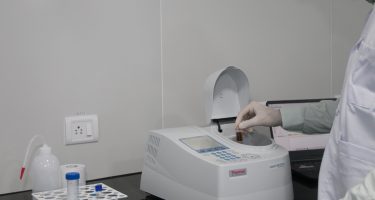 An UV-VIS spectrophotometer which determines concentration of compounds in fluid samples based on amount of light absorbed at specific wavelengths.